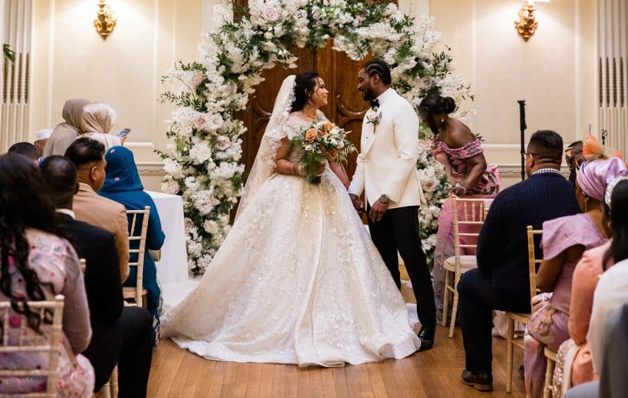 Bride and Groom under flower arch